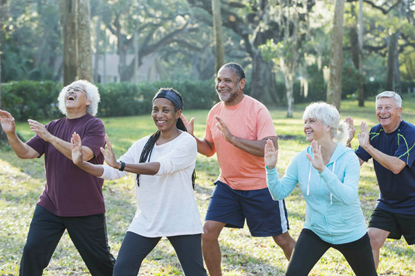 Group of older people exercising outdoors
