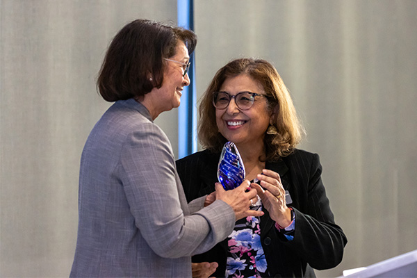 Dean Hakim give Dr. Cecilia Rosales an award for her 18 years at
        the UA
